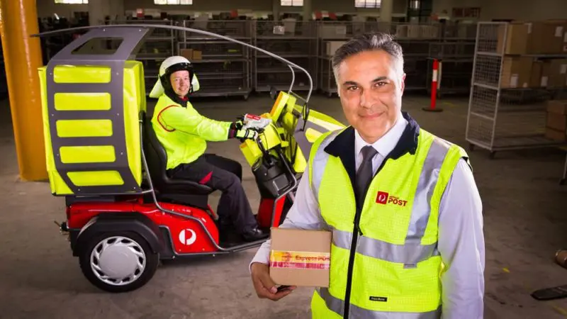 Australia Post Managing Director and Group CEO Ahmed Fahour and Postal Delivery Officer Ron Previllian with the new electric delivery vehicle. Supplied.