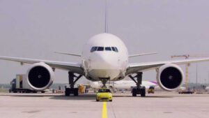 Electric Mini Cooper proves massive towing power by pulling Boeing cargo plane