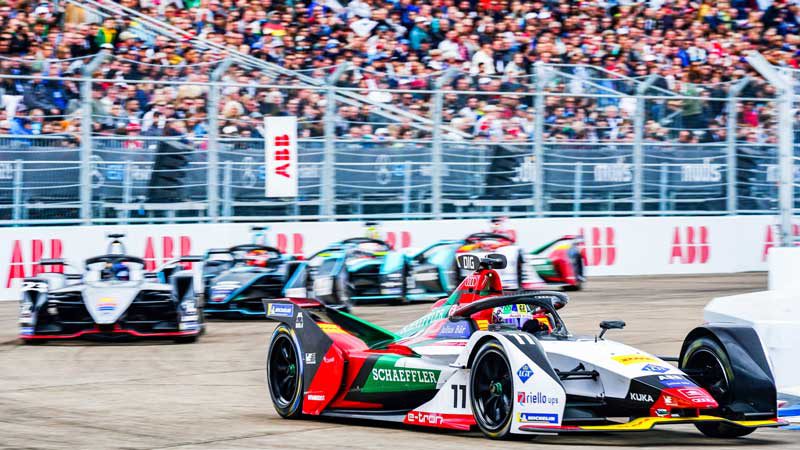 Cars pulling into parc ferme on the podium at Tempelhof Airport, with Sebastien Buemi (Nissan e.dams) congratulating first-place finisher Lucas di Grassi