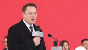 Tesla shares climb as Elon Musk wins top gong and flags break-even quarter