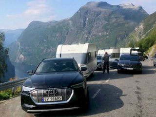 tesla and audi e-tron pulling caravan
