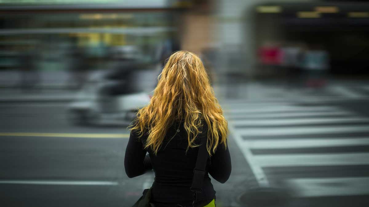 woman waiting to cross road