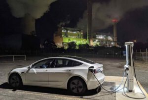 Heaven and hell? Caption this photo of EV charging in front of coal plant