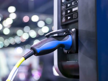 AGL will partner with Wilson Parking to deploy 18 'smart' electric vehicle charing stations. (Credit: Canva).
