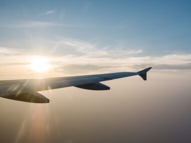 airplane wing and sunset on blue sky