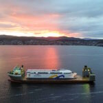 World’s largest battery-electric ship leave Tasmania piggy-backed aboard a giant heavy lift vessel