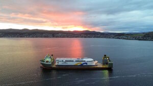 World’s largest battery-electric ship leave Tasmania piggy-backed aboard a giant heavy lift vessel