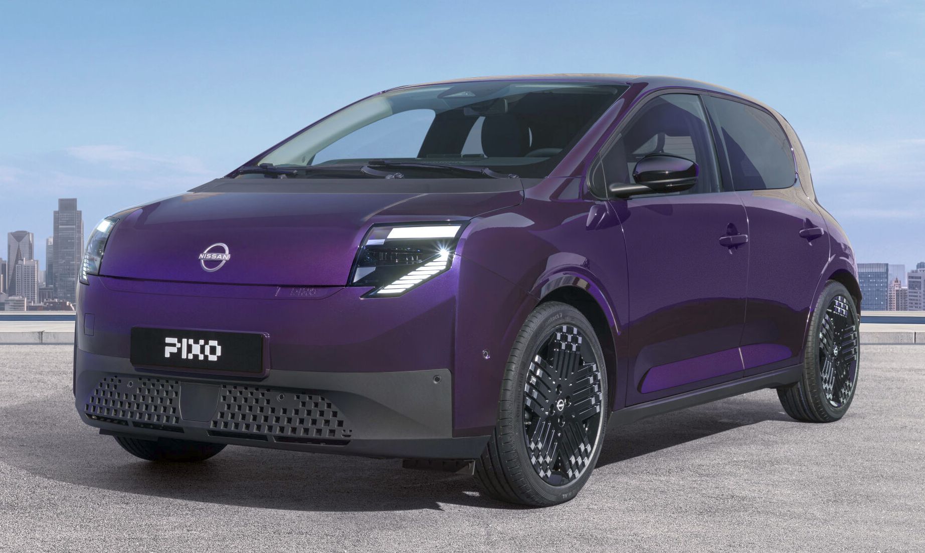 Three-quarter front view of a purple Nissan PIXO electric city car parked beneath a modern concrete structure, with a city skyline in the background.